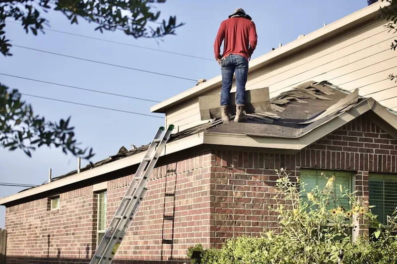 Professional roofer working on a residential roof in Pea Ridge
